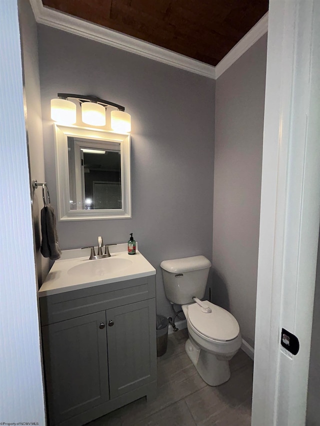 bathroom with vanity, toilet, and crown molding