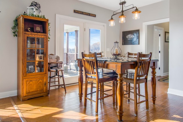 dining room with an inviting chandelier and light hardwood / wood-style flooring