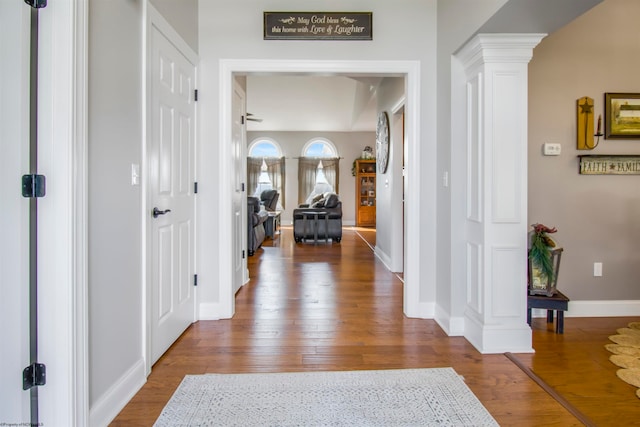 entrance foyer featuring wood-type flooring, ornate columns, and ceiling fan