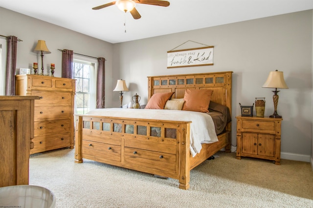 bedroom with ceiling fan and light carpet