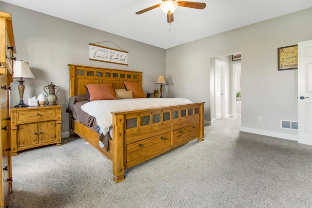 bedroom with ceiling fan and light carpet