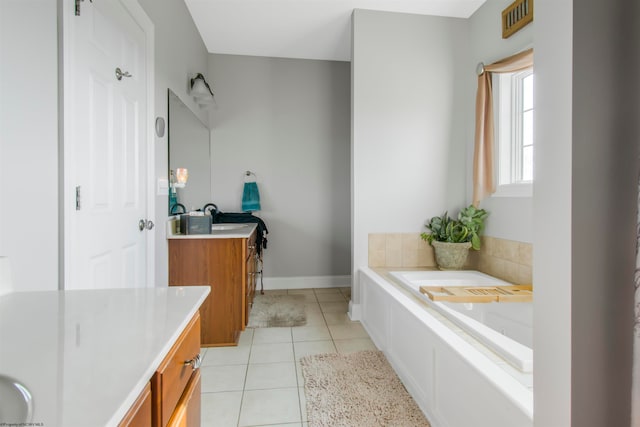 bathroom featuring tile patterned floors, a bathtub, and vanity