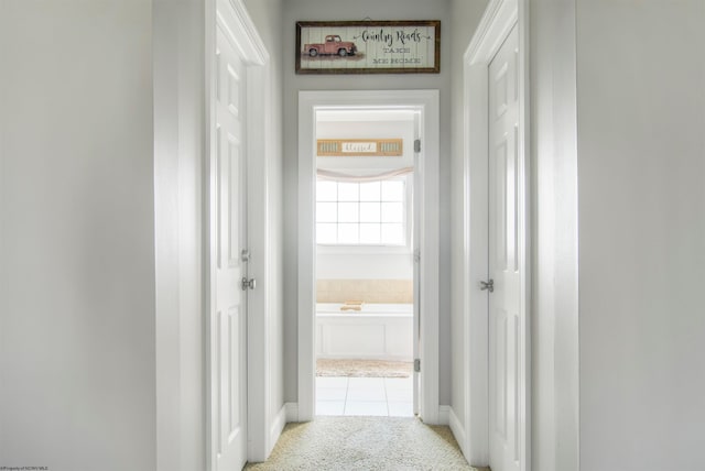 hallway featuring light tile patterned floors