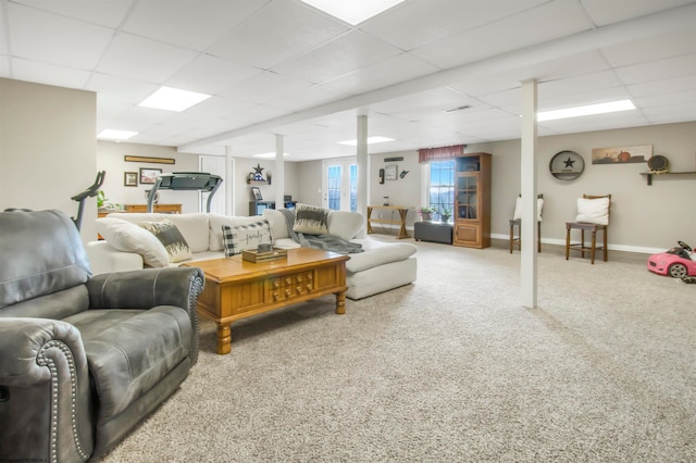 carpeted living room with a paneled ceiling