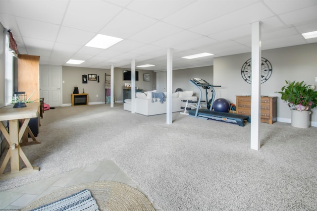 workout room with a paneled ceiling and carpet