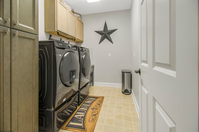 laundry room featuring cabinets and washing machine and clothes dryer