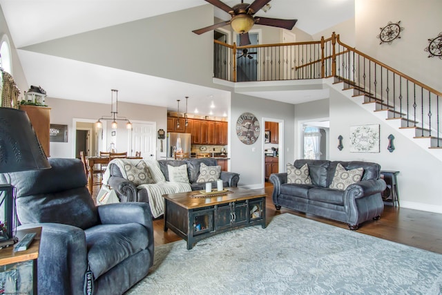 living room with wood-type flooring, high vaulted ceiling, and ceiling fan