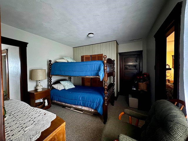 carpeted bedroom with a textured ceiling