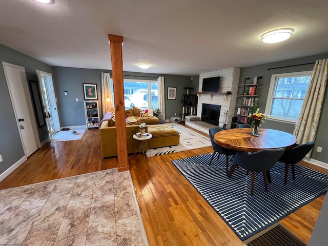 living room with a fireplace, a textured ceiling, and hardwood / wood-style flooring