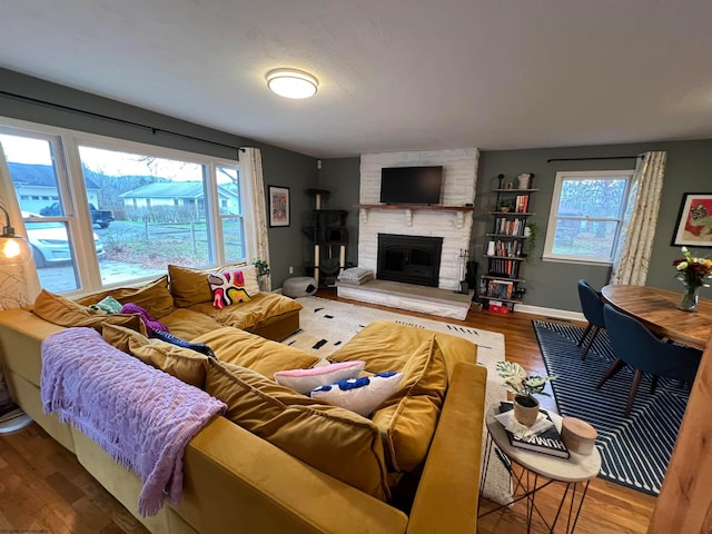 living room featuring hardwood / wood-style flooring, a healthy amount of sunlight, and a fireplace