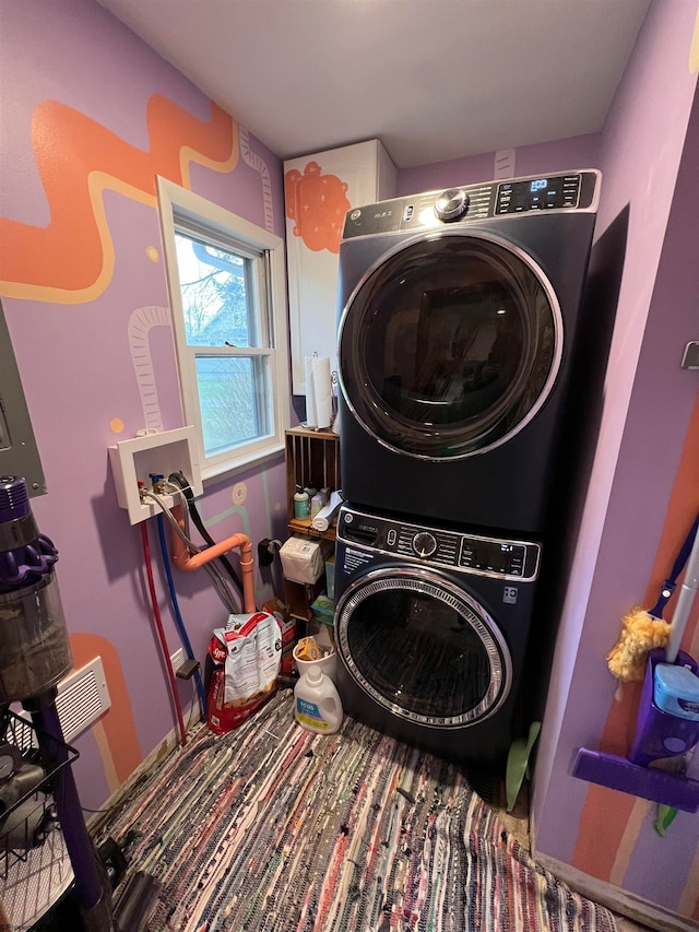 laundry area with stacked washer and dryer