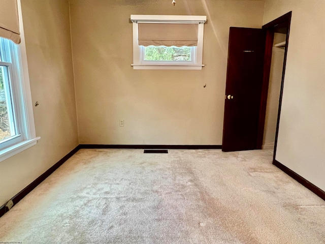 carpeted empty room featuring a healthy amount of sunlight