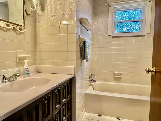 bathroom featuring vanity, shower / bath combination, and tile walls