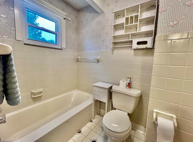 bathroom featuring tile patterned flooring, toilet, tile walls, and a tub