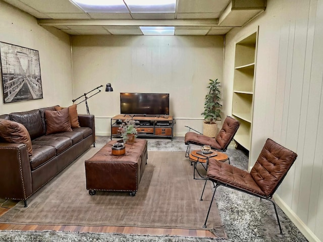 living room featuring a drop ceiling