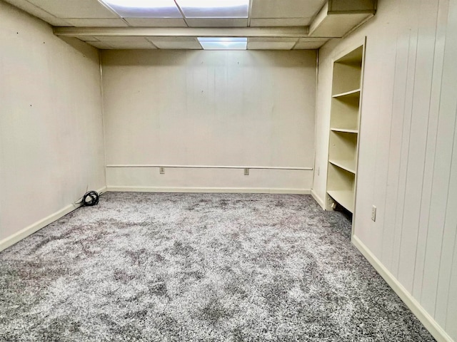 carpeted spare room featuring a paneled ceiling