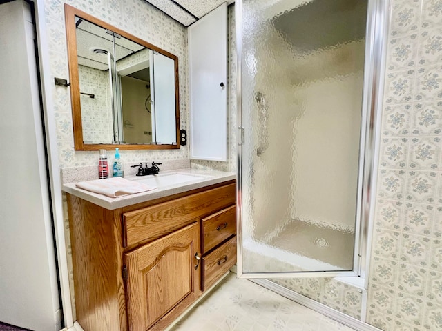 bathroom featuring vanity and an enclosed shower