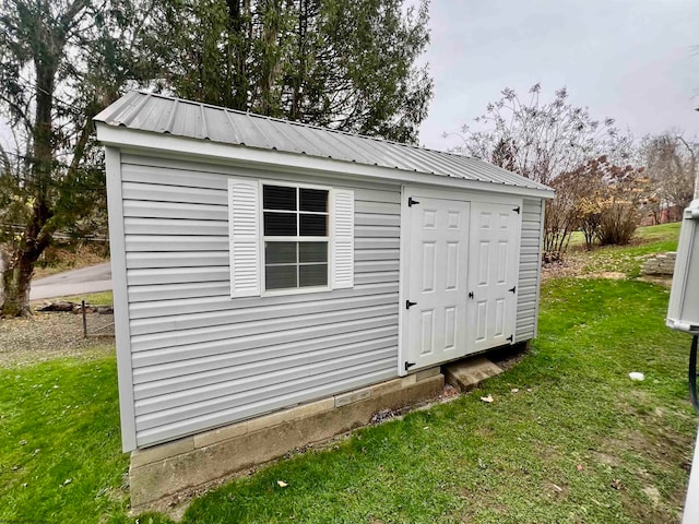 view of outbuilding with a lawn