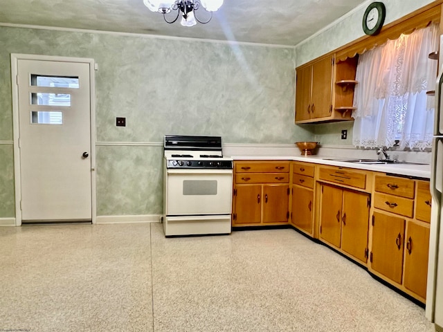 kitchen with a wealth of natural light, sink, white range, and a notable chandelier