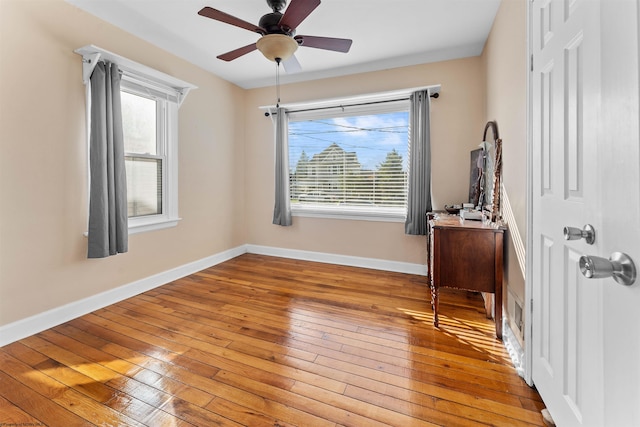 unfurnished room with ceiling fan, a healthy amount of sunlight, and light hardwood / wood-style floors