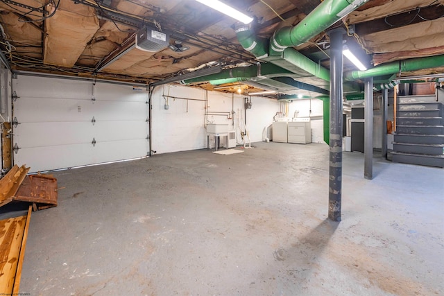 garage featuring washer and dryer and a garage door opener