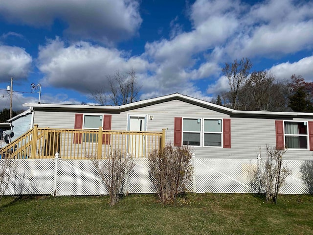 back of house with a yard and a deck