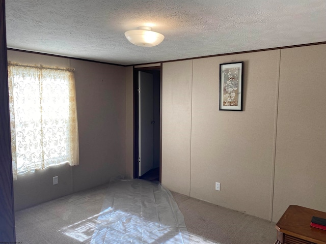 unfurnished room with a textured ceiling and a healthy amount of sunlight