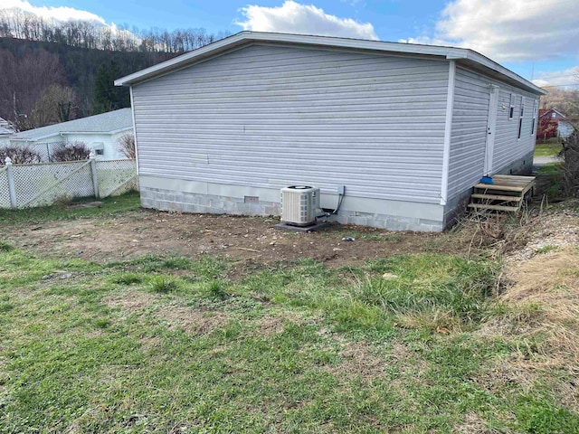 view of side of property featuring central AC unit