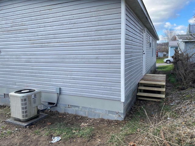 view of side of property featuring central air condition unit