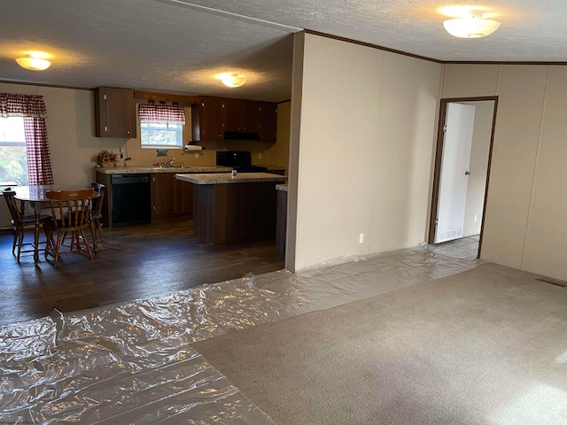 kitchen featuring black appliances, a kitchen island, dark wood-type flooring, and a wealth of natural light