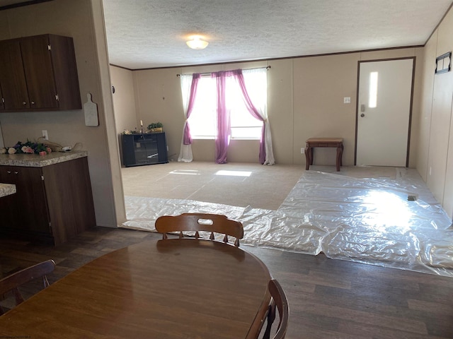 dining room with hardwood / wood-style flooring and a textured ceiling