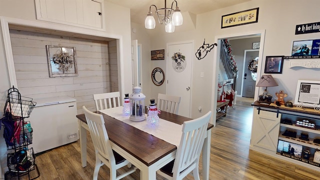 dining area featuring dark hardwood / wood-style floors and an inviting chandelier