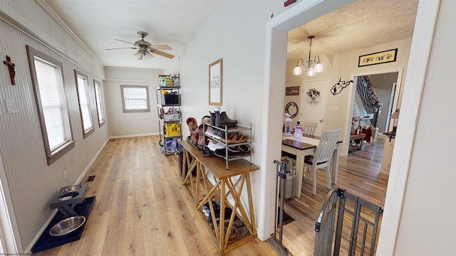 dining room featuring ceiling fan with notable chandelier and hardwood / wood-style flooring