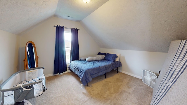 bedroom with light colored carpet, lofted ceiling, and a textured ceiling