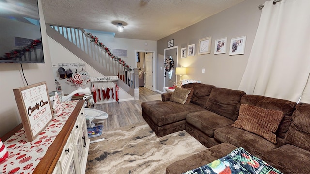 living room with light hardwood / wood-style flooring and a textured ceiling