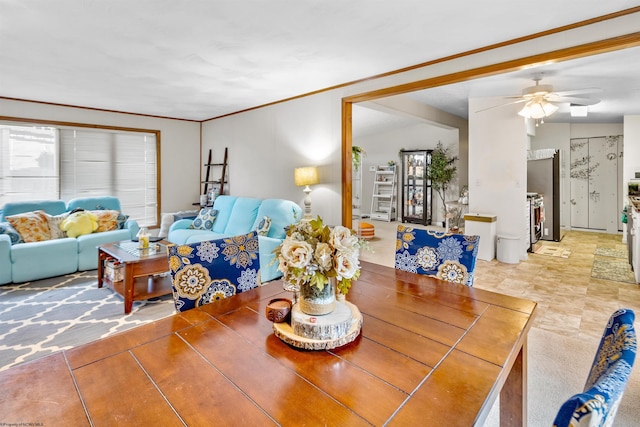 dining area featuring ceiling fan, ornamental molding, and vaulted ceiling