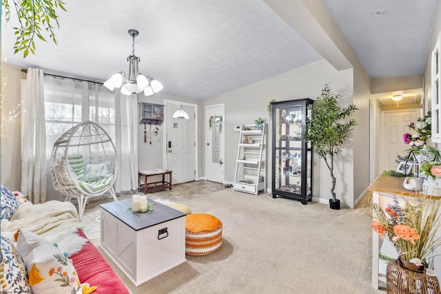 carpeted living room with a textured ceiling, an inviting chandelier, and lofted ceiling