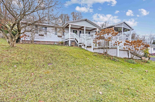 view of front of house with a sunroom and a front yard