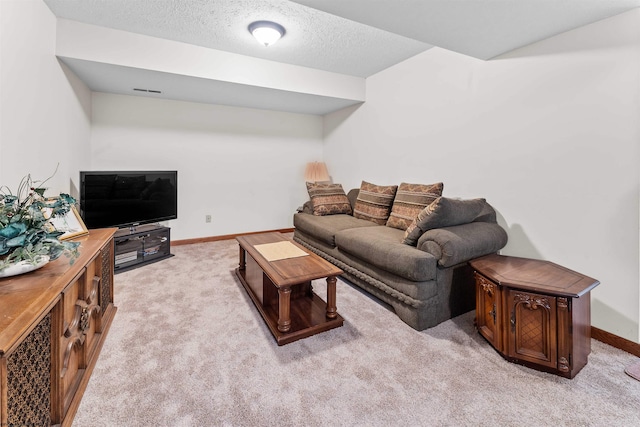 living room with a textured ceiling and light carpet