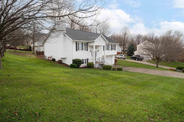 bi-level home featuring a garage and a front lawn