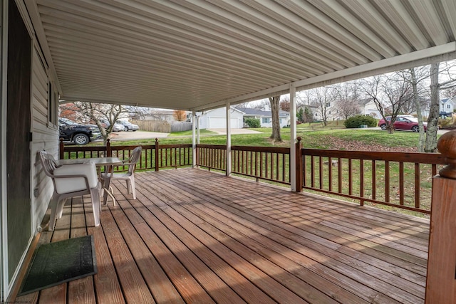 wooden deck featuring a lawn