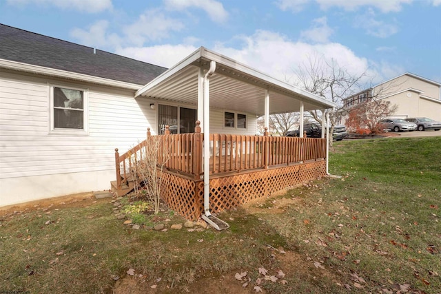 rear view of property featuring covered porch and a lawn