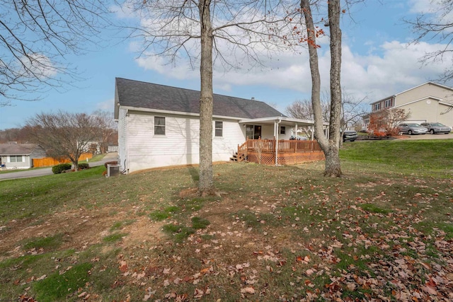 back of house with a porch and a yard