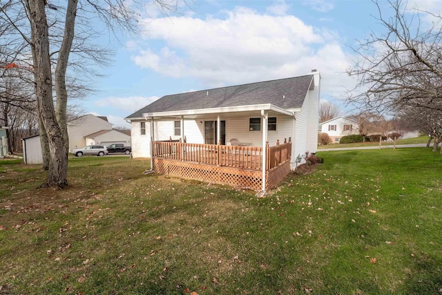 back of house with a lawn