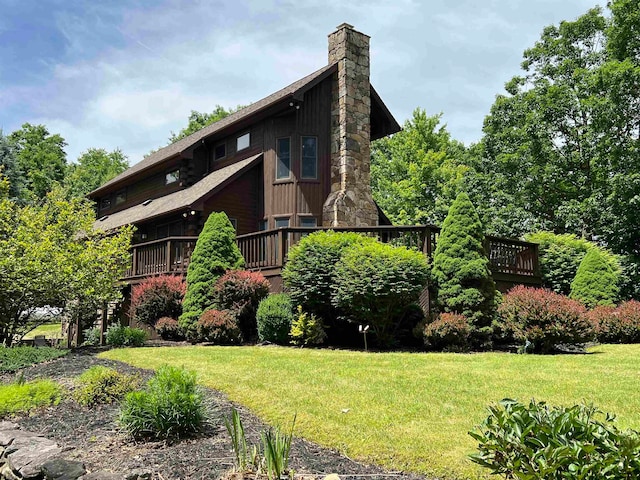 view of side of property with a lawn