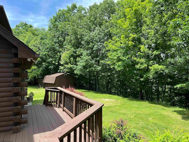 deck featuring a lawn and a storage shed