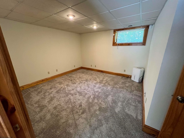 carpeted spare room with a drop ceiling