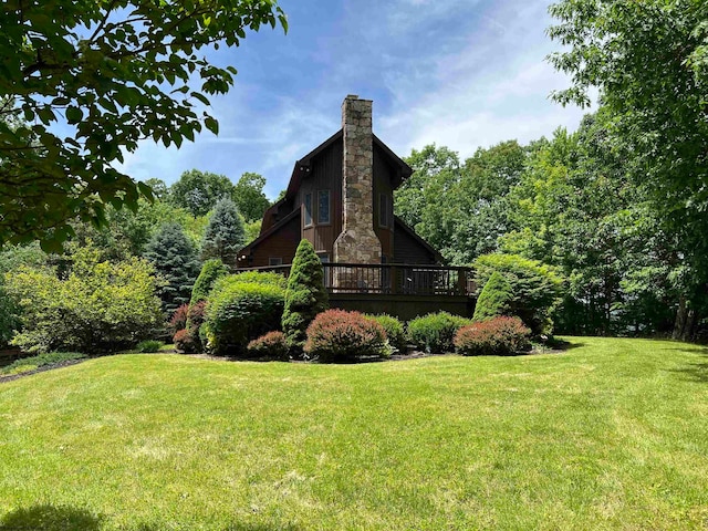 exterior space featuring a lawn and a deck