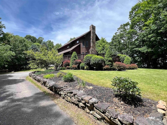 view of side of property with a lawn