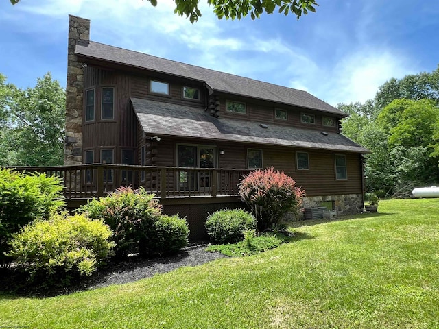 back of house with a lawn and a wooden deck